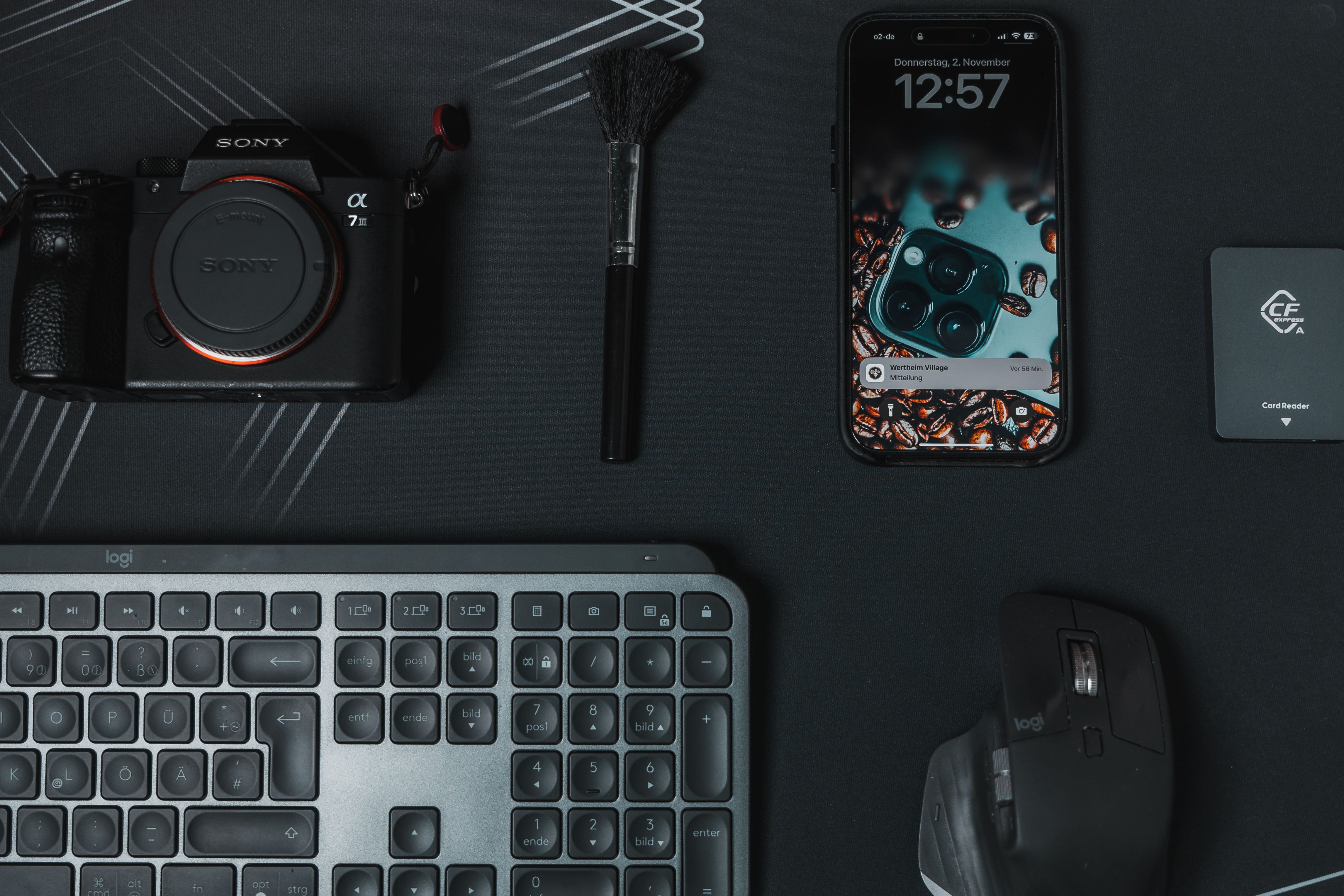 Flat lay of modern tech gadgets including camera smartphone and keyboard